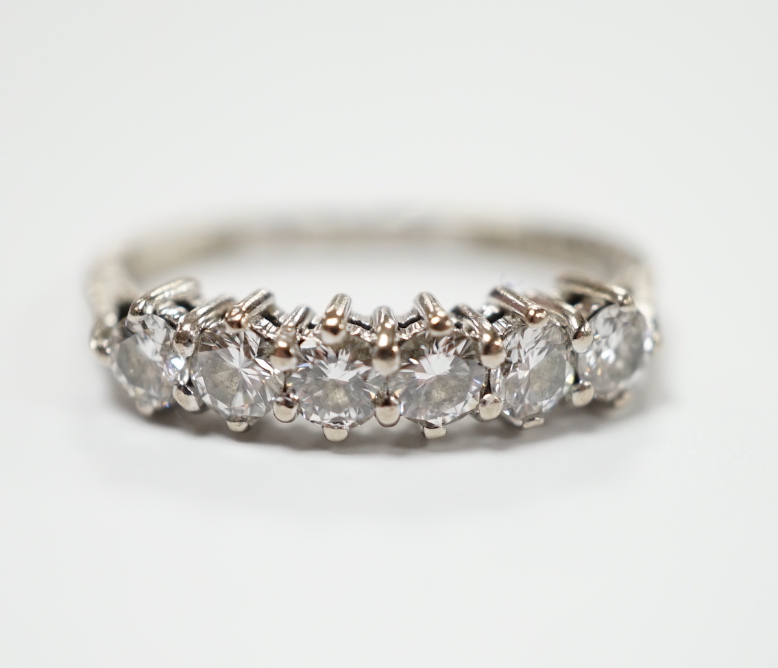 A modern 18ct white gold and six stone diamond set half hoop ring, (shank slightly crushed), gross weight 3.4 grams.